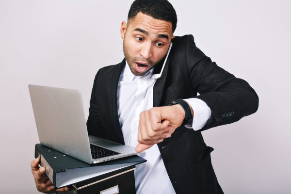 busy-handsome-guy-white-shirt-black-jacket-talking-phone-holding-folders-laptop-looks-astonished-watch-being-late-meeting-office-worker-career